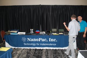 NanoPac exhibitor booth displaying several lo and high tech assistive devices